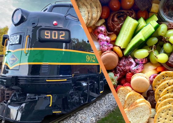 Reading Blue Mountain & Northern locomotive 902 beside a charcuterie spread with crackers, grapes, cucumber, cheese, and sweets.