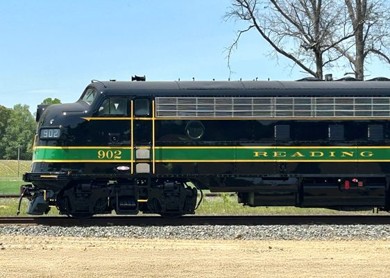 Scenic rambler image rolling down the track with green grass and trees